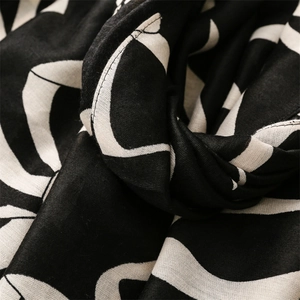 Macro shot of abstract black and white print scarf with natural cotton linen texture