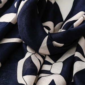 Close-up of navy and beige cotton linen scarf showing geometric texture and soft fabric folds