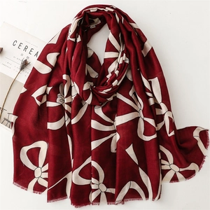 Deep red cotton linen scarf with white abstract bow prints and fringed edges