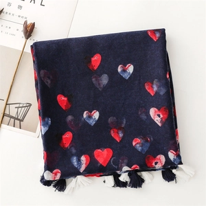 Detail of navy blue cotton linen scarf with heart print and black white fringe tassels