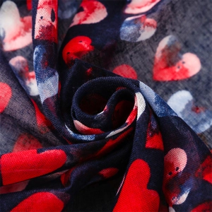 Detail view showing navy heart print scarf fabric texture and lightweight drape