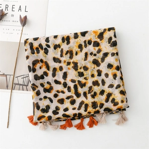Close-up of leopard print scarf with orange tassels and soft cotton-linen texture