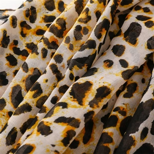 Macro shot of lightweight leopard print fabric showing fine weave texture and drape