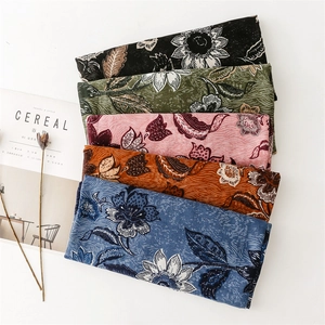 Detail of five floral cotton linen scarves in various vintage colors with flower patterns