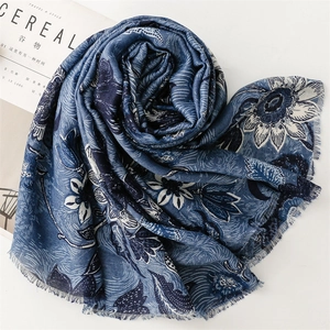 Close-up of deep blue floral cotton linen scarf with elegant fringe detail and soft texture