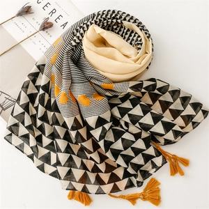 Detail of geometric triangle print scarf with yellow tassels and double-layer fabric