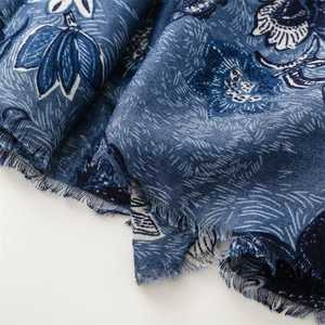 Close-up of indigo blue floral print scarf with soft texture and frayed edges