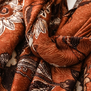Macro shot of boho floral cotton linen scarf with vintage orange flower patterns