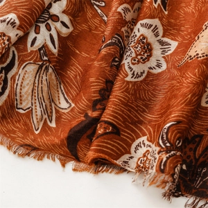 Detailed close-up of cotton-linen scarf with vintage peony floral print and frayed edges