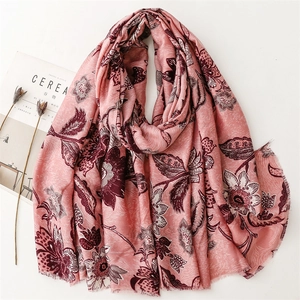 Detail of light pink floral scarf with frayed edges and artistic peony print texture