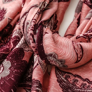 Close-up of cotton linen scarf showing pink floral peony pattern and fabric texture
