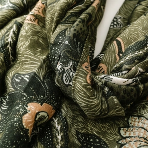 Close-up of floral linen scarf showing soft fabric texture and green peony pattern