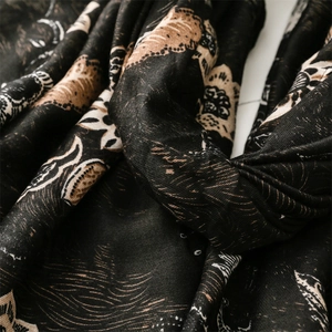 Close-up of vintage peony floral pattern on thick black cotton-linen feel winter scarf