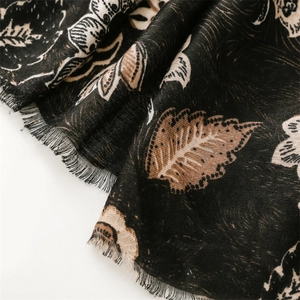 Detailed macro view of vintage floral cotton linen scarf with soft fringe edges