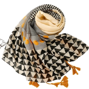 Linen-feel shawl with black geometric triangles, yellow polka dots and tassel fringe