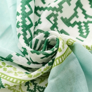 Detail shot of green geometric cotton linen scarf fabric with silver metallic threads