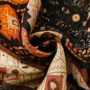 Macro detail of bohemian geometric patterns on a textured cotton linen blend shawl
