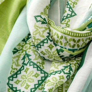 Close-up of green bohemian geometric scarf showing cotton linen texture and drape
