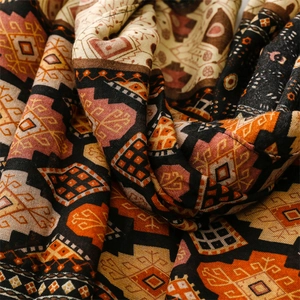 Detail of bohemian geometric shawl with rich ethnic patterns and woven cotton texture