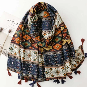 Close-up of bohemian geometric scarf featuring ethnic patterns and fringe tassels
