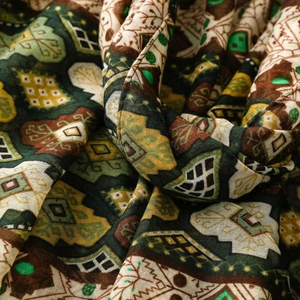 Macro shot of bohemian geometric patterns and fine linen texture on a dark shawl
