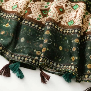 Detailed view of bohemian geometric scarf fabric with soft texture and two-tone tassels