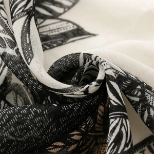 Detailed macro shot of cotton-linen feel scarf with leaf print and woven texture