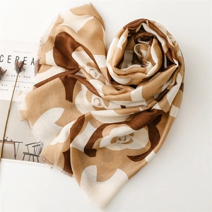 Detail of camellia floral scarf arranged in a heart shape on a white aesthetic background