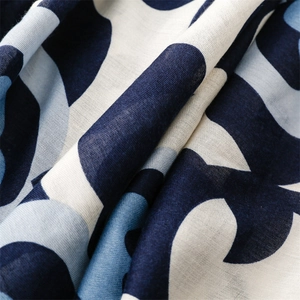 Macro view of khaki camellia print linen-feel scarf showing fine textile texture