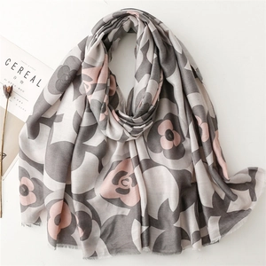 Detail of camellia flower print scarf with frayed edges and cereal magazine styling
