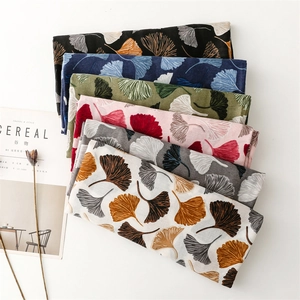 Detailed close-up showing six various color options of scarves with ginkgo leaf patterns