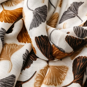 Macro detail of linen texture and ginkgo leaf patterns on a lightweight scarf