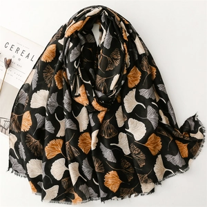 Black cotton linen scarf featuring white and yellow ginkgo leaf patterns and soft fringes