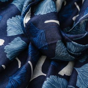 Close-up of Ginkgo leaf pattern on navy scarf with detailed machine-stitched edges