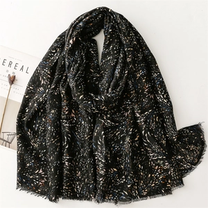 Elegant black cotton linen scarf with blue orange feather print and raw fringe edges