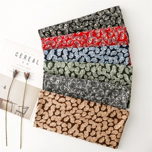 Detail of soft scarves featuring ginkgo leaf patterns in multiple elegant color options