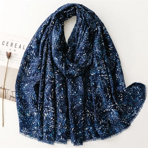 Detail view of navy blue cotton linen scarf with elegant gold feather foil print
