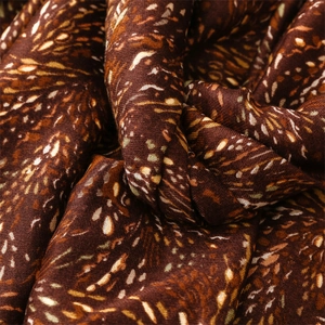 Macro view of scarf fabric showing soft cotton linen texture and brown wheat pattern