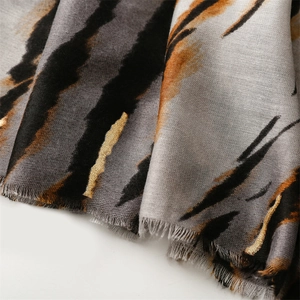 Macro shot of tiger pattern texture and fringe edge detail on a cotton-linen feel scarf