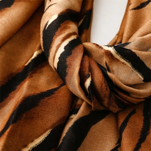 Close-up of zebra pattern gradient scarf with soft texture and golden satin finish