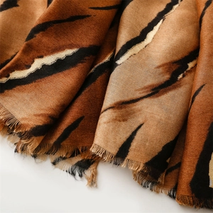 Detailed close-up of tiger stripe pattern and frayed edges on cotton-linen feel shawl