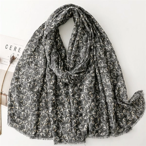 Detail shot of dark grey cotton linen scarf with silver ginkgo pattern and fringe edges
