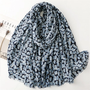Navy linen scarf with gold gingko leaf pattern and frayed edges on white background