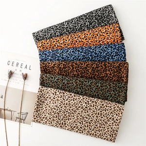 Close-up of leopard print scarves in multiple colors like orange, blue, and brown