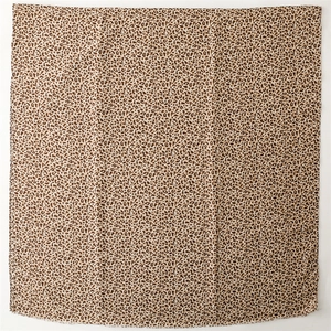 Detail shot of leopard print scarf featuring classic brown and black animal pattern