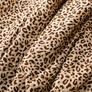 Close-up of leopard print scarf fabric showing soft linen-feel texture and fine weave