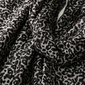 Close-up of leopard print cotton-linen scarf fabric texture in black and grey tones