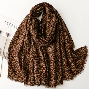 Classic leopard print shawl with fringe edges on a minimalist lifestyle background