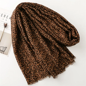 Detail of leopard print scarf featuring frayed edges and soft linen texture