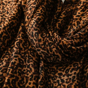 Macro view of leopard print woven fabric texture with detailed fiber weave and folds